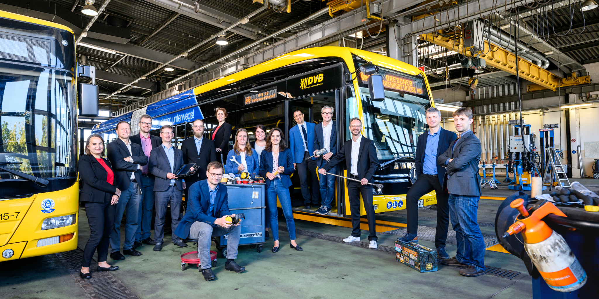 Das Team von Probst & Consorten in einem Betriebshof der DVB vor einem Bus